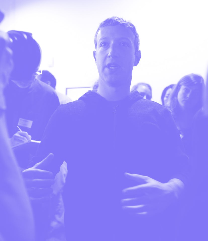 Mark Zuckerberg (center) speaks to a media after a press conference where a redesign of Facebook's ...