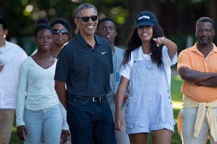 US President Barack Obama and his daughter Malia Obama walk during a visit to the Honolulu Zoo Janua...