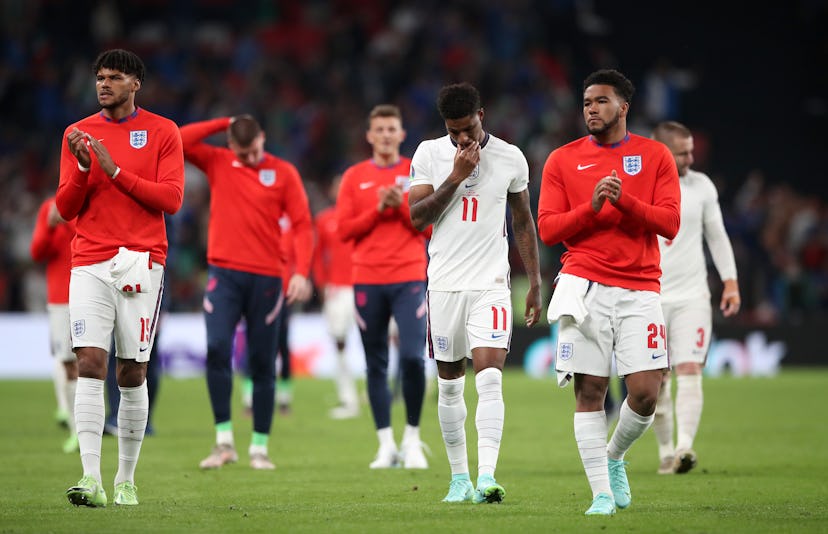 England's Tyrone Mings (left), Marcus Rashford (centre) and Reece James following defeat in the pena...