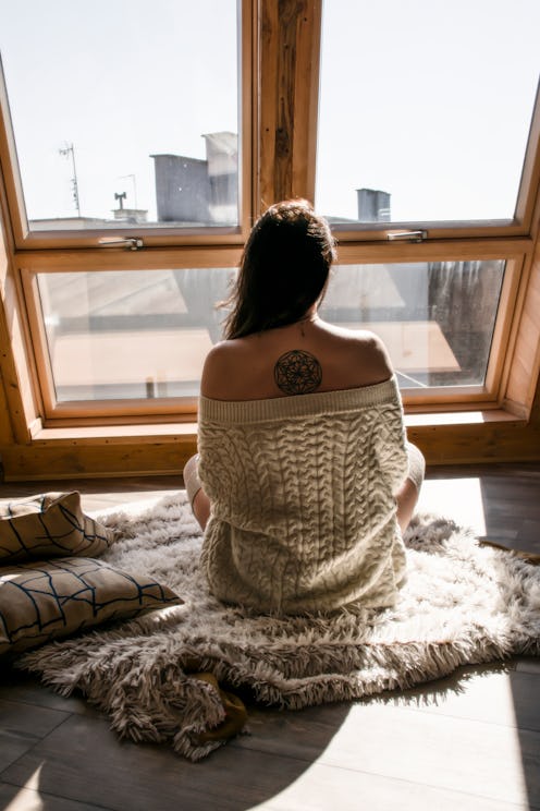 woman looking out her window