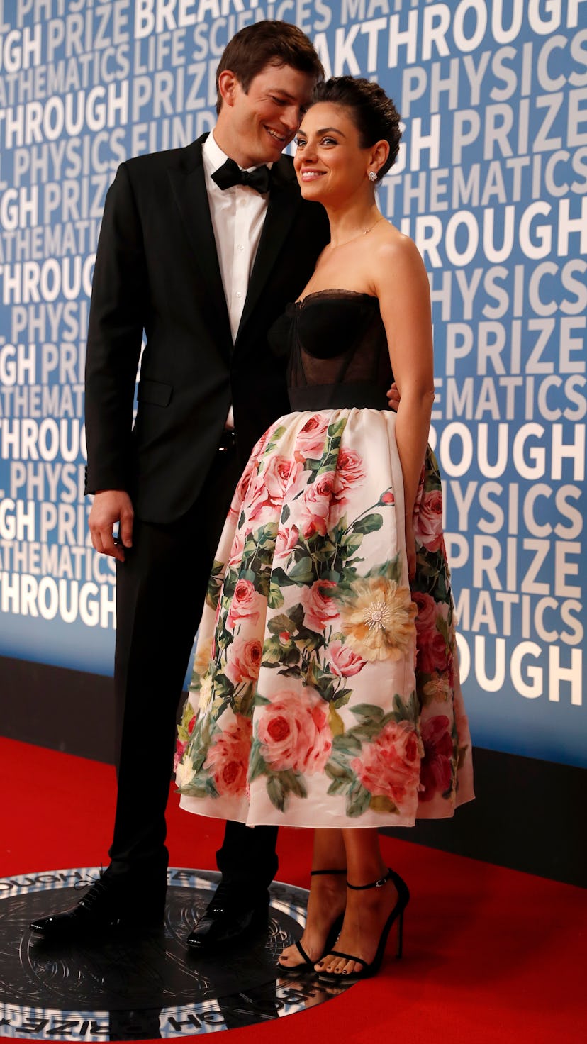 Actress Mila Kunis poses for a picture with her husband actor Ashton Kutcher on the red carpet for t...