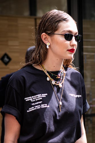 PARIS, FRANCE - JUNE 19: Gigi Hadid, wearing black sunglasses and black Off-White printed t-shirt, i...
