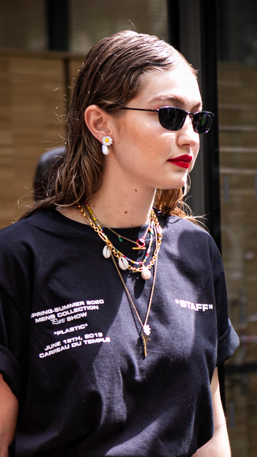 PARIS, FRANCE - JUNE 19: Gigi Hadid, wearing black sunglasses and black Off-White printed t-shirt, i...