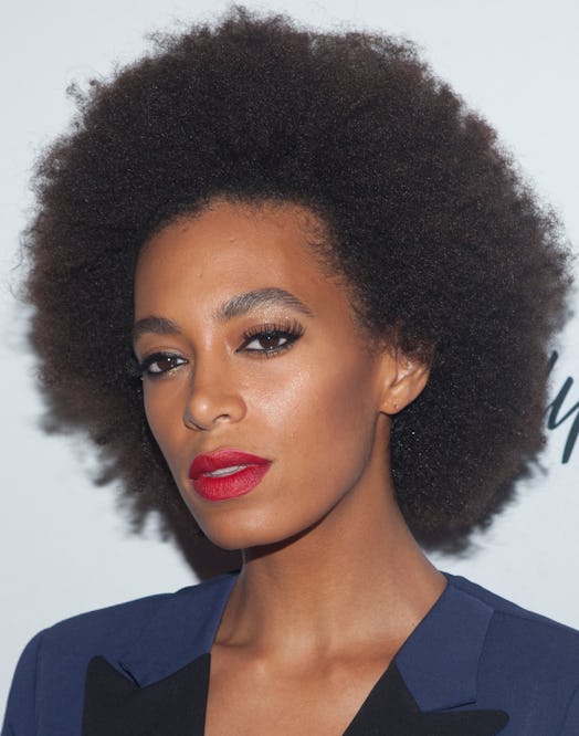 Solange Knowles in a pink-tinged red lipstick.