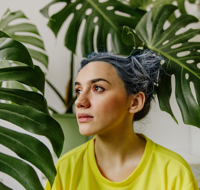 A young woman with blue hair wearing the perfect messy bun