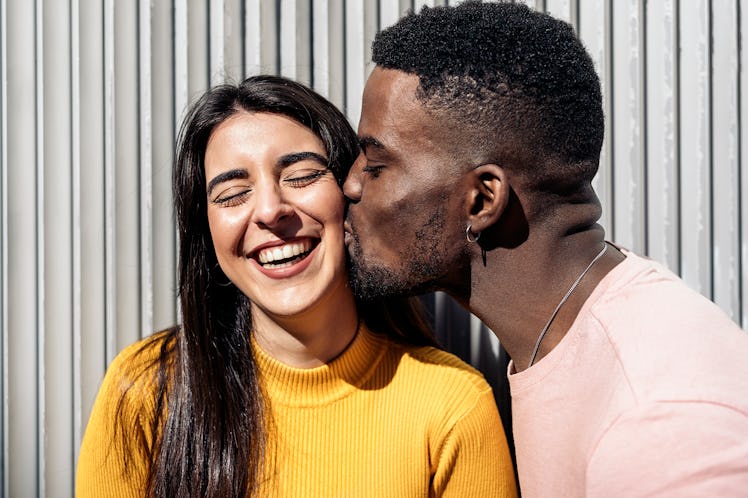 A Cancer man gives a Virgo woman a kiss.