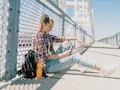 A teenager in the city with backpack looks at some POV TikTok video ideas for back-to-school videos....