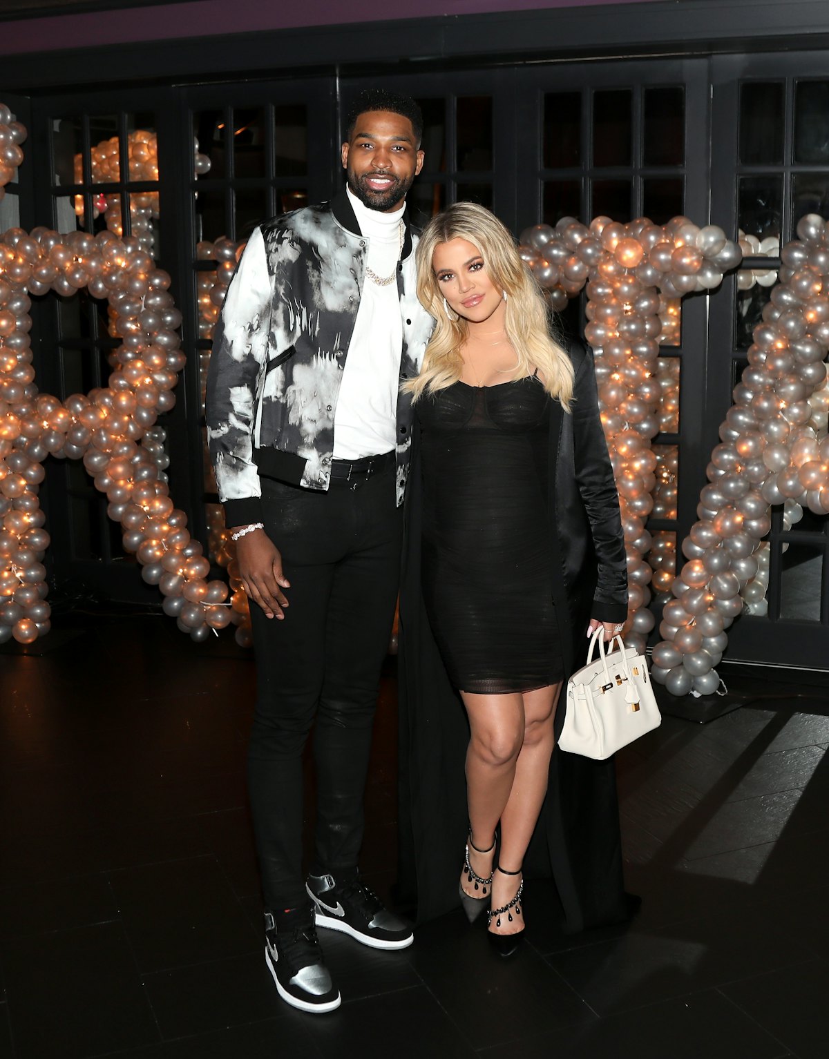 LOS ANGELES, CA - MARCH 10: Tristan Thompson and Khloe Kardashian pose for a photo as Remy Martin c ...