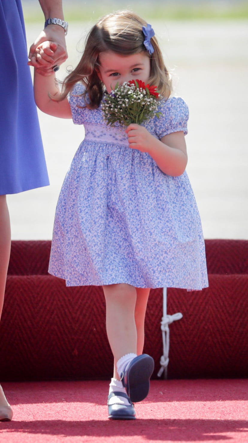 Princess Charlotte smells the roses.