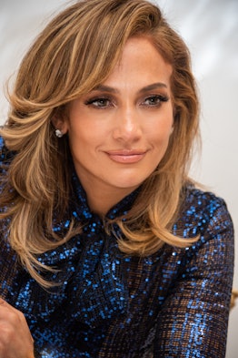 Jennifer Lopez wears side-swept curtain bangs with her ends curled.