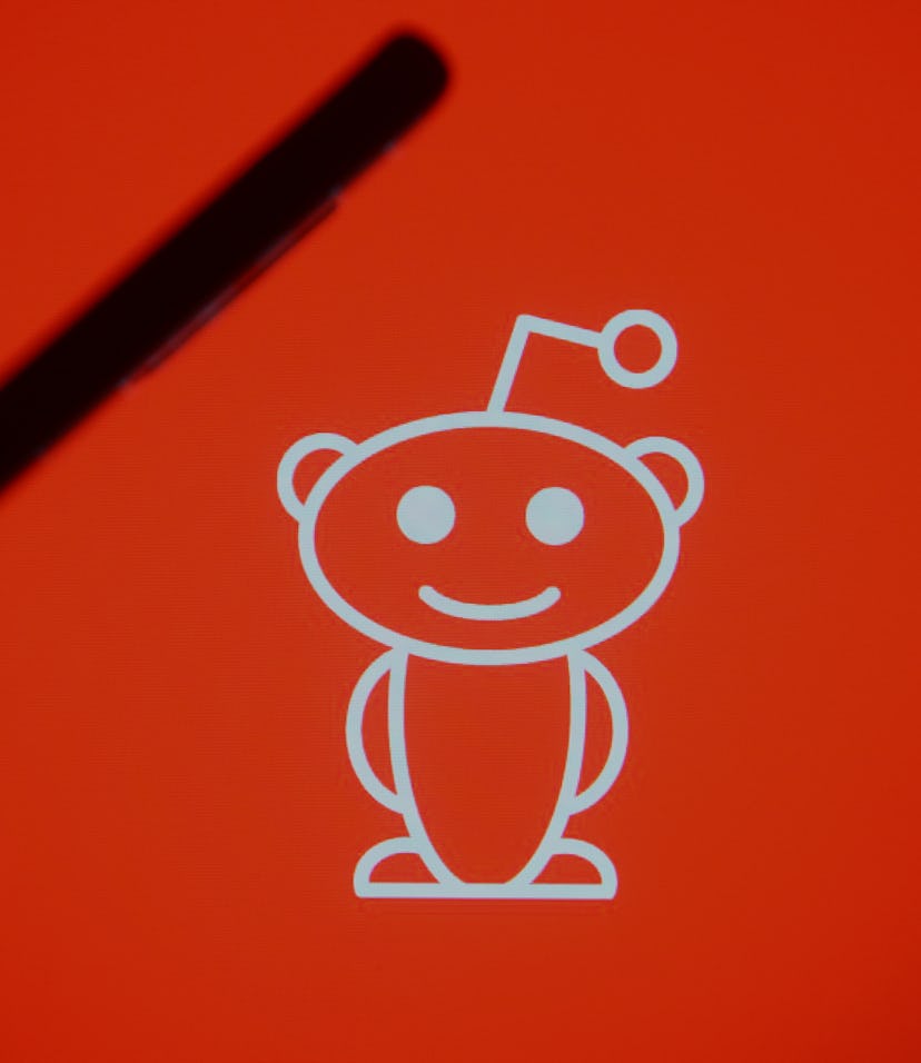 UKRAINE - 2021/03/07: In this photo illustration a silhouette hand holding a mobile phone with a Red...