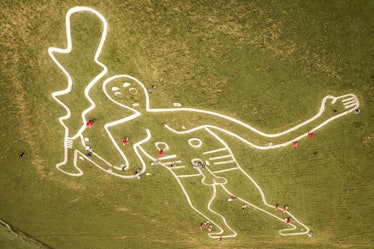 Volunteers work to repair and refresh the Cerne Abbas Giant in Dorset, where people are working with...