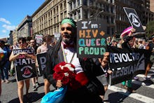 NEW YORK, NY - JUNE 30:  An activists holds a sign in support of sufferers of HIV during the Queer L...