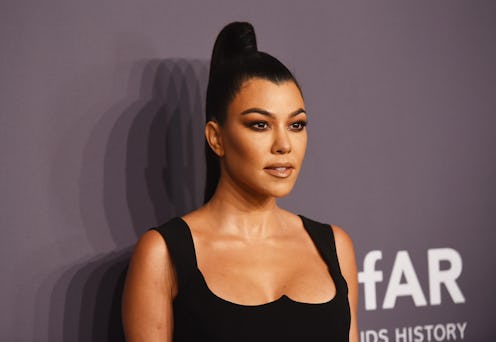 Kourtney Kardashian's 2000s outfits run the gamut from metallic mini dresses to lacy corset tops. Se...