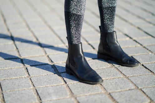 PARIS, FRANCE - JANUARY 10: Amanda Derhy wears gray shiny glitter socks from Intimissimi, black leat...