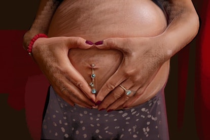Hands that make a heart shape on a pregnant woman's stomach