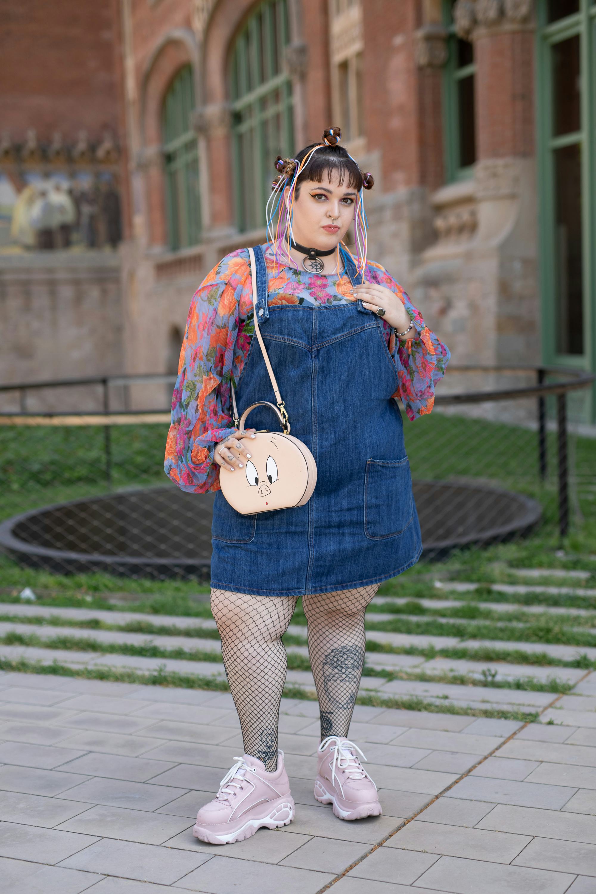 Plus-size influencer beautifully styles a pair of denim overalls as a dress with a long sleeve top, ...