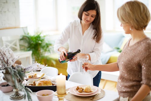 Young adult women servicing table for Christmas dinner