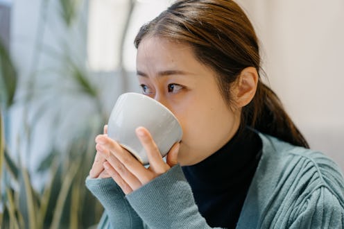 woman drinking a cup of coffee