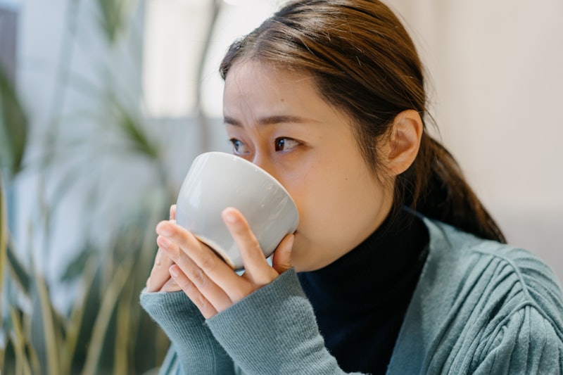woman drinking a cup of coffee