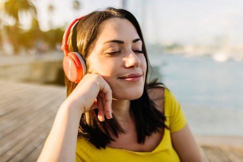 woman relaxing listening to music outside