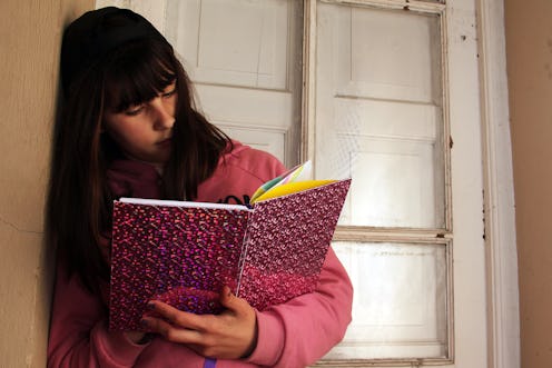 young girl reading a book