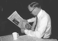 View of an unidentified man as he reads a copy of the New York Times, New York, New York, August 14,...