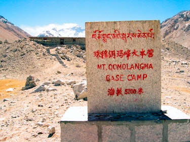 Mount Qomolangma Base Camp stone marker Mount Everest beyond Himalayas Tibet. (Photo by: Andrew Wood...