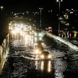 DETROIT, MICHIGAN, UNITED STATES - 2021/07/24: Vehicles cautiously drive through floodwaters on I-94...