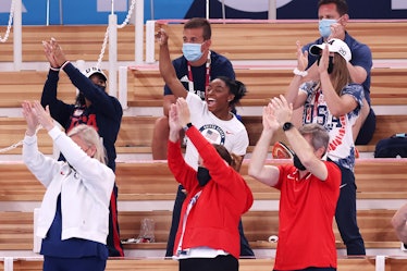 Simone Biles cheers on her teammates at the Tokyo Olympics.