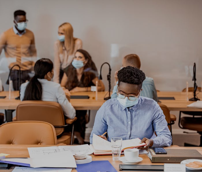 Businesswoman reviews documents during COVID-19 pandemic