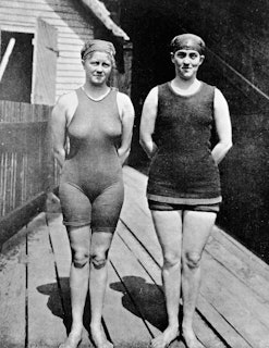Australian swimmer Mina Wylie (1891 - 1984) (left) and Fanny Durack (1889 - 1956) pose together, han...