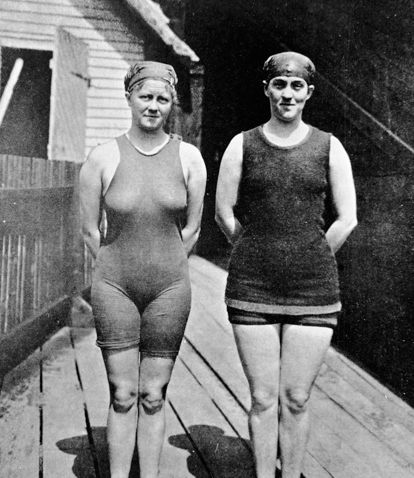 Australian swimmer Mina Wylie (1891 - 1984) (left) and Fanny Durack (1889 - 1956) pose together, han...