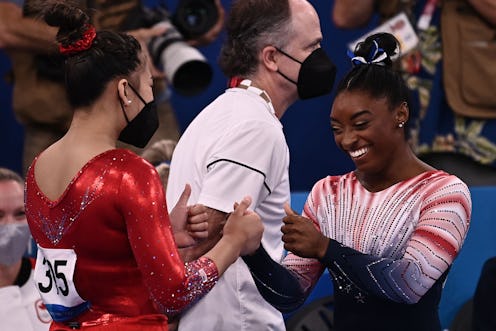 USA's Simone Biles (R) is congratulated by USA's Sunisa Lee after competing in the artistic gymnasti...