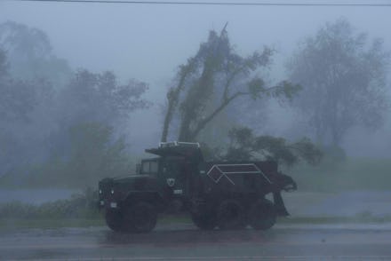 TOPSHOT - A truck is seen in heavy winds and rain from hurricane Ida in Bourg, Louisiana on August 2...