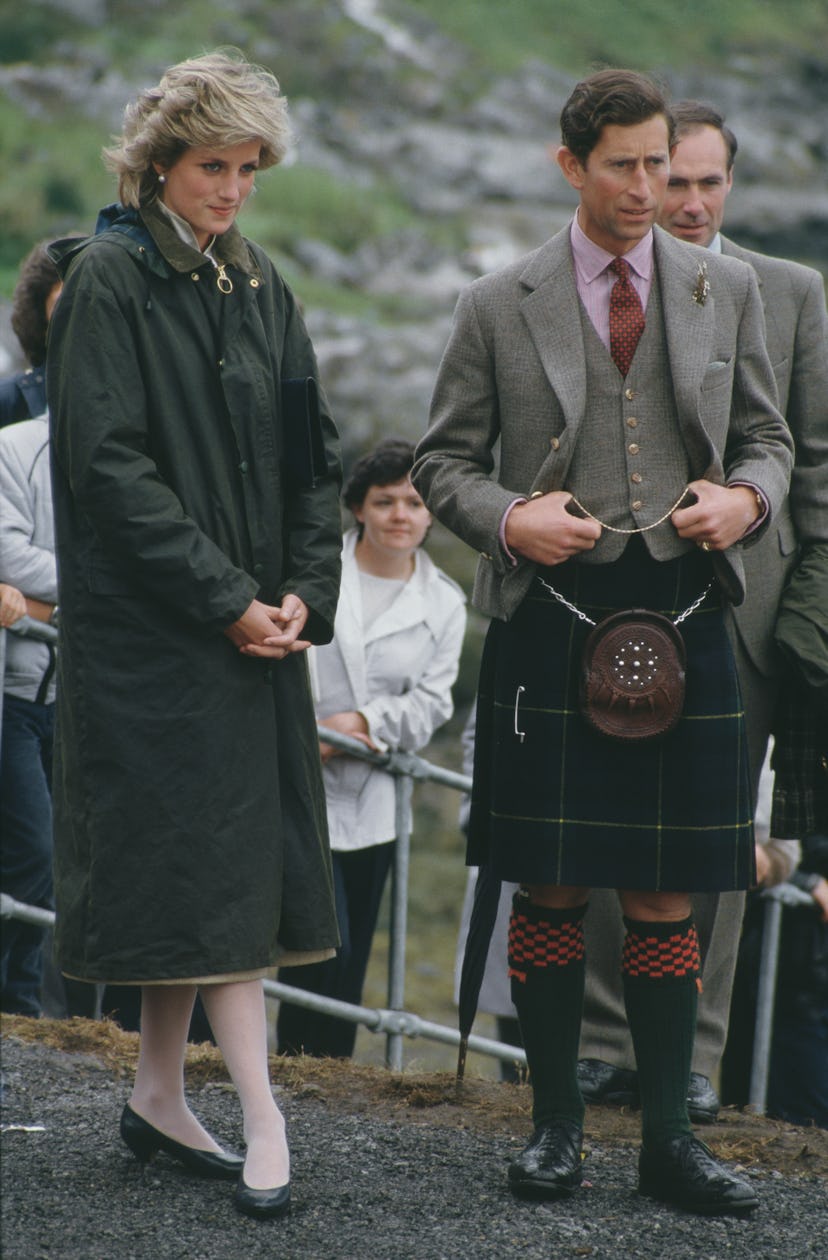 Princess Diana wears a long coat in rainy weather.