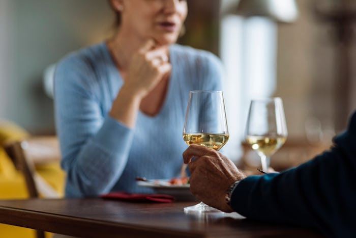 Unrecognisable couple having dinner and wine in a restaurant