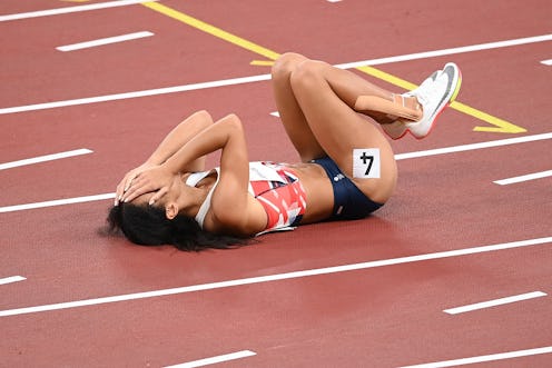 TOKYO, JAPAN - AUGUST 04: Katarina Johnson-Thompson of Team Great Britain reacts as she lies injured...