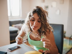 Woman makes TikTok's churro cheesecake by mixing the ingredients from the recipe together. 