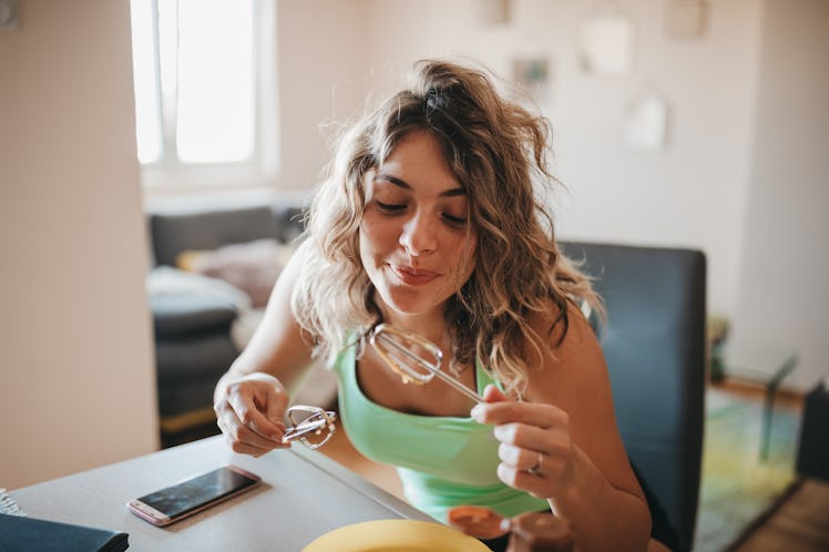 Woman makes TikTok's churro cheesecake by mixing the ingredients from the recipe together.