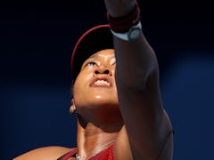 TOKYO, JAPAN - JULY 25: Naomi Osaka of Team Japan serves during her Women's Singles First Round matc...