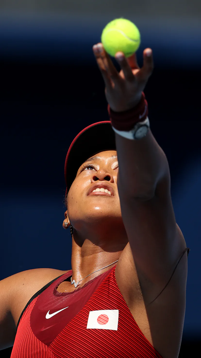 TOKYO, JAPAN - JULY 25: Naomi Osaka of Team Japan serves during her Women's Singles First Round matc...