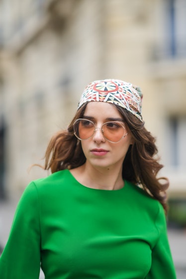 Ketevan Giorgadze  wears a midi green dress with a round neckline from Zara, oversized sunglasses fr...