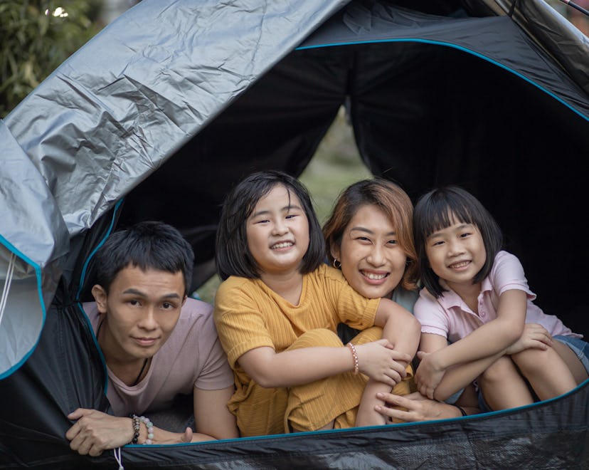 family playing have fun inside camping tent at backyard
