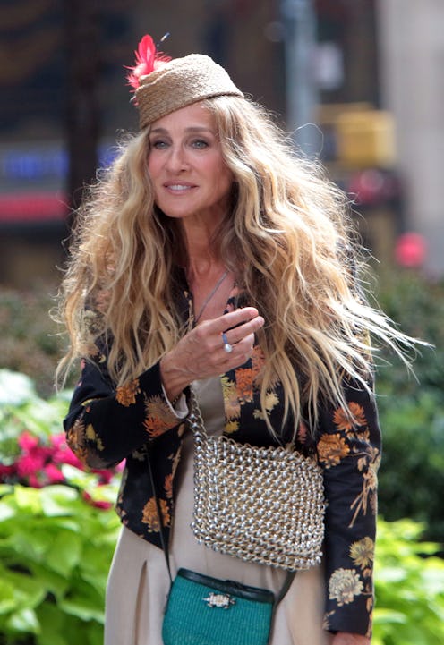 Sarah Jessica Parker photographed in an embroidered jacket and chainmail bag while on set for And Ju...
