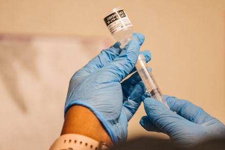 HOUSTON, TEXAS - MAY 13: A volunteer healthcare provider prepares Covid-19 vaccine doses on May 13,...