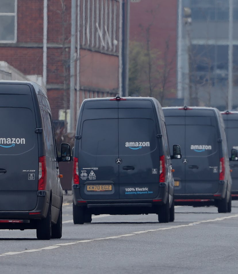 Electric delivery vans leave the Amazon warehouse in the Titanic Quarter, Belfast. Picture date: Wed...
