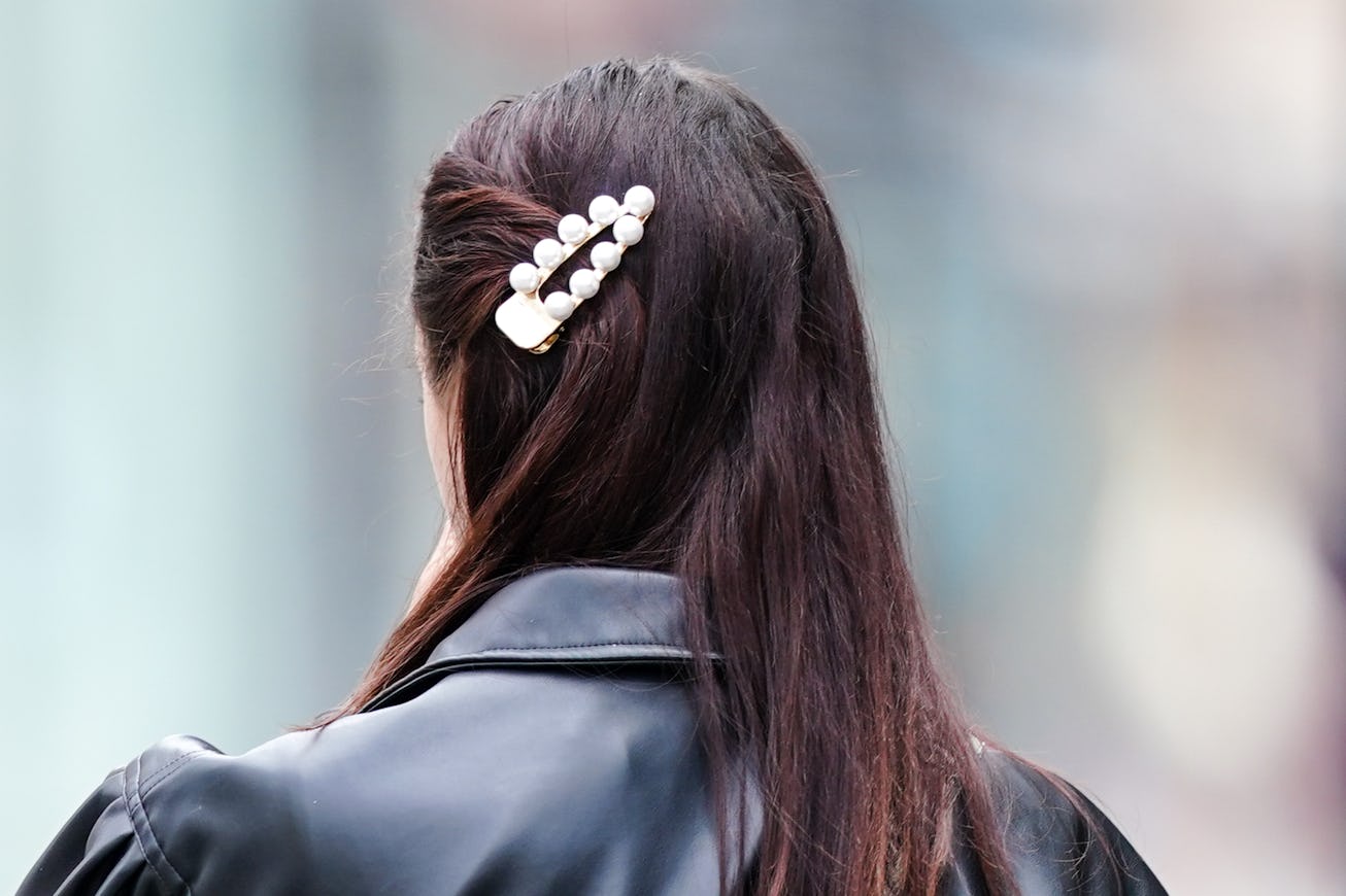 PARIS, FRANCE - JUNE 07: A passerby wears a beaded pearls hair brooch, on June 07, 2020 in Paris, Fr...