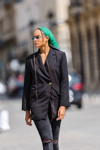 Alicia Aylies wears a green bandana scarf in the way classic early 2000s celebrities wore bandanas.