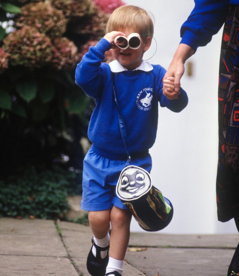 LONDON - SEPTEMBER 16: Prince Harry looks at photographers as he leaves on his first day at Mrs. M...